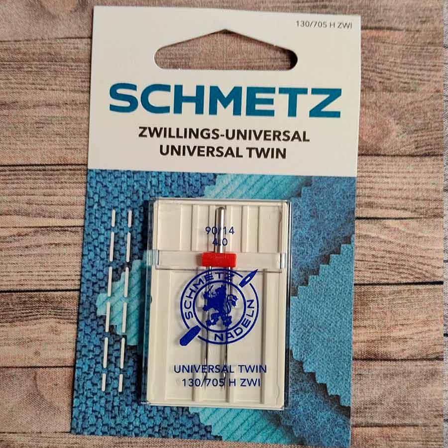 Aguja doble Schmetz Universal Twin para máquina de coser doméstica, grosor 90/14 y separación de 4,0 mm.