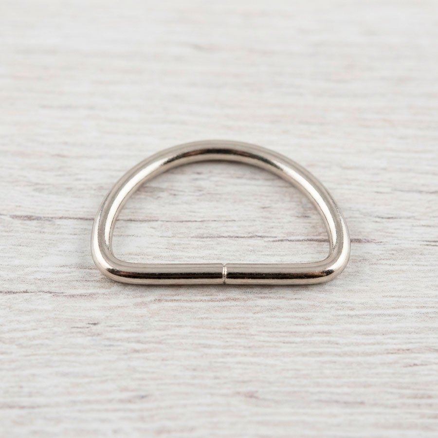 Anilla en forma de media luna (D-ring) color plata de 2,5 cm para enganche de mosquetones en bolsos.